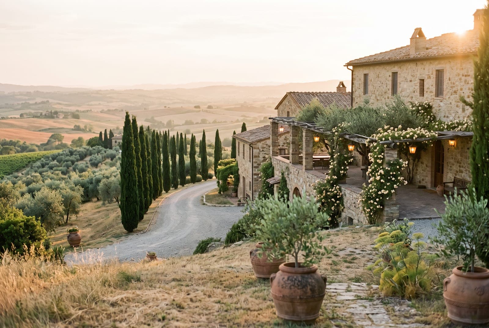 A Tuscan hilltop villa with a rose-covered pergola at golden hour
