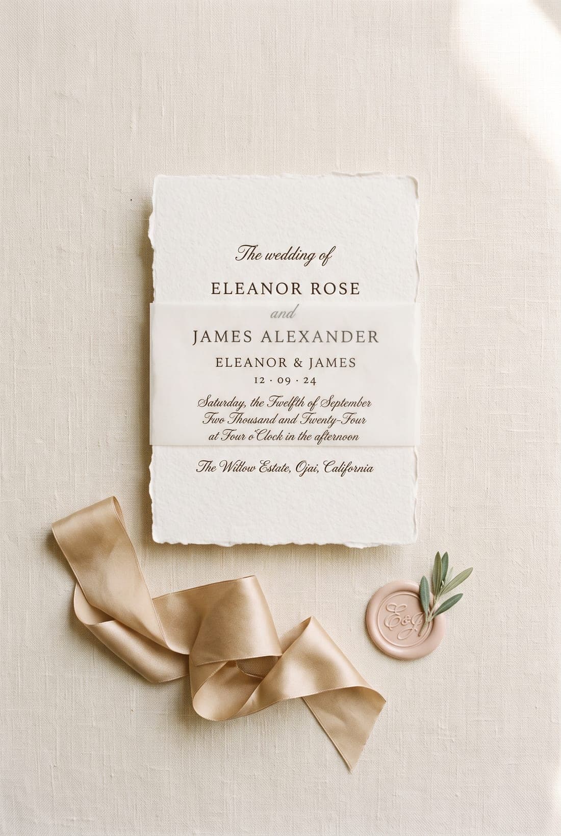 A letterpress wedding invitation suite with silk ribbon and a wax seal